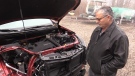 Elgin King looks at his damaged Chevrolet Equinox that he’s been waiting over six months to be fixed. One part missing, that GM Canada says hasn’t been available due to supply chain issues – January 12, 2023, Bayfield (Scott Miller/CTV News London)