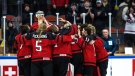 Canadian players celebrate with the trophy after winning the Women's U18 Ice Hockey World Championship match between Canada and Sweden in Ostersund Arena in Ostersund, Sweden, Jan. 15, 2023. (Per Danielsson/TT News Agency via AP)