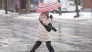A person holds an umbrella as rain falls on Friday, Dec. 23, 2022. (THE CANADIAN PRESS/Graham Hughes)