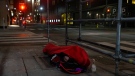 A homeless man sleeps on the street, in Toronto, on Friday, March 11, 2022. THE CANADIAN PRESS/Chris Young