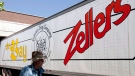 A man walks past a Zellers transport truck outside a Zellers store in Lynn Valley in North Vancouver, B.C., Thursday, July, 26, 2012. The first 25 of a new generation of Zellers stores will open within Hudson's Bay locations in 2023, Hudson's Bay Co. has announced. THE CANADIAN PRESS/Jonathan Hayward