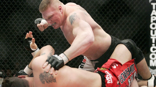 In this Feb. 2, 2008, file photo, Brock Lesnar, top, fights Frank Mir during the first round of the Ultimate Fighting Championship 81 heavyweight bout at Mandalay Bay Events Center in Las Vegas. (AP Photo/Las Vegas Review-Journal, Ronda Churchill) 