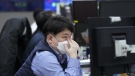 A currency trader watches monitors at the foreign exchange dealing room of the KEB Hana Bank headquarters in Seoul, South Korea, Thursday, Jan. 19, 2023. Asian shares were trading mixed Thursday, as investors grew cautious after Wall Street's biggest pullback of the year. (AP Photo/Ahn Young-joon)