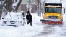 An area resident digs out their car in Halifax after an overnight snowfall. (THE CANADIAN PRESS/Andrew Vaughan)