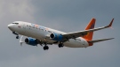 A Sunwing Boeing 737-800 passenger plane prepares to land at Pearson International Airport in Toronto on August 2, 2017. THE CANADIAN PRESS/Christopher Katsarov