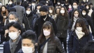 Commuters wear masks outside Tokyo Station in Tokyo Friday, Jan. 20, 2023. Japan's Prime Minister Fumio Kishida on Friday announced plans to start preparations for downgrading legal status of COVID-19 to an equivalent of seasonal influenza in the spring, a move that would further relax mask wearing and other preventive measures as the country seeks an exit plan. (Kyodo News via AP)