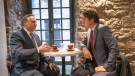 Prime Minister Justin Trudeau and Quebec Premier Francois Legault chat over coffee in a coffee shop in Montreal, on Tuesday, December 20, 2022. THE CANADIAN PRESS/Paul Chiasson