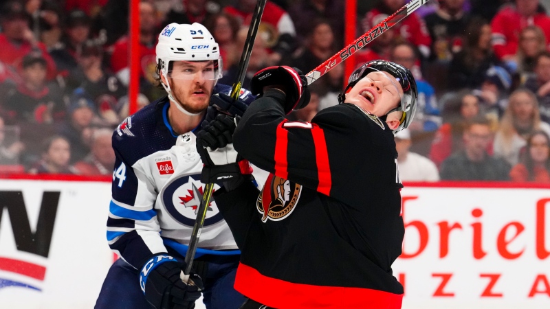 Ottawa Senators left wing Brady Tkachuk (7) reacts to a stick check from Winnipeg Jets defenceman Dylan Samberg (54) during second period NHL hockey action in Ottawa on Saturday, Jan. 21, 2023. (Sean Kilpatrick/THE CANADIAN PRESS)