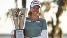 Brooke Henderson holds up the championship trophy after winning the LPGA Hilton Grand Vacations Tournament of Champions, Sunday, Jan. 22, 2023, in Orlando, Fla. (AP Photo/John Raoux)