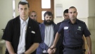 Yosef Haim Ben David, center, arrives at Jerusalem court during his murder trial in the death of a 16-year-old Palestinian boy, in Jerusalem, Tuesday, March 22, 2016. (AP Photo/Mahmoud Illean, File)