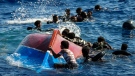 Migrants swim next to their overturned wooden boat during a rescue operation by Spanish NGO Open Arms at south of the Italian Lampedusa island at the Mediterranean sea, Thursday, Aug. 11, 2022. Forty migrants from Eritrea and Sudan were rescued after their boat overturned and started to sink. A new report on African governance released Jan. 25, 2023, finds much of the continent is "less safe, secure and democratic" than it was 10 years ago, citing a surge in military coups and armed conflicts. (AP Photo/Francisco Seco)