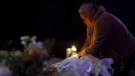 Merced Martinez places a candle at a memorial for victims of the mass shooting the day before in Half Moon Bay, Calif., Tuesday, Jan. 24, 2023. (Carlos Avila Gonzalez/San Francisco Chronicle via AP)