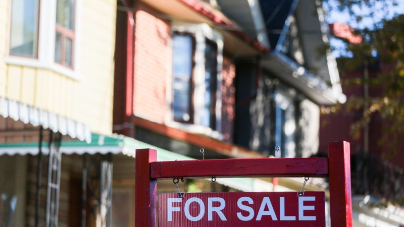 A real estate sign is displayed in front of a house in the Riverdale area of Toronto on Wednesday, September 29, 2021.THE CANADIAN PRESS/Evan Buhler