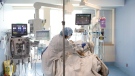 A nurse tends to a patient in the intensive care unit at the Bluewater Health Hospital in Sarnia, Ont., on Tuesday, January 25, 2022. THE CANADIAN PRESS/Chris Young