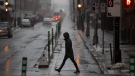 A pedestrian crosses a street in Halifax during a rainfall warning for much of Nova Scotia on Monday, January 23, 2023. THE CANADIAN PRESS/Darren Calabrese