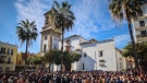 Residents gather after a minute of silence for a church sacristan who was killed Wednesday in Algeciras, southern Spain, on Jan. 26, 2023. (Juan Carlos Toro / AP)