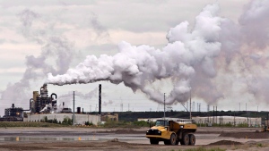 A dump truck works near the Syncrude oil sands extraction facility near the city of Fort McMurray, Alberta on Sunday June 1, 2014.  THE CANADIAN PRESS/Jason Franson