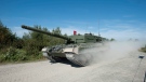 The new Canadian Forces Leopard 2A4 tank makes its way onto the firing range for a demonstration at CFB Gagetown in Oromocto, N.B., on Thursday, September 13, 2012. Defense Minister Peter MacKay visited CFB Gagetown to announce the arrival of the new tanks. THE CANADIAN PRESS/David Smith