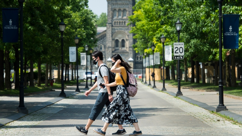 People walk past the University of Toronto campus on Wednesday, June 10, 2020. THE CANADIAN PRESS/Nathan Denette
