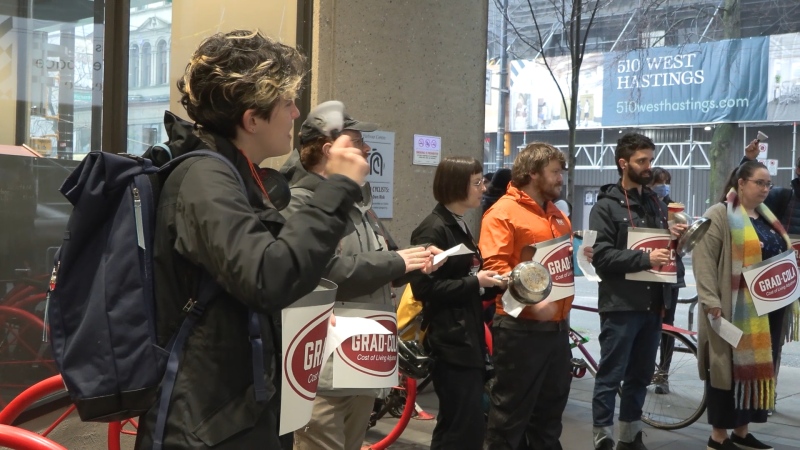 Dozens of grad students and staff from Simon Fraser University gathered outside the SFU Board of Governors meeting at the Vancouver Campus on Thursday morning to protest against what they call a "student funding crisis" at the university.