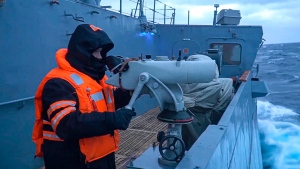 In this handout photo taken from video released by the Russian Defence Ministry Press Service, Jan. 10, 2023, a sailor is seen on duty aboard the Admiral Gorshkov frigate of the Russian navy. (Russian Defense Ministry Press Service via AP)