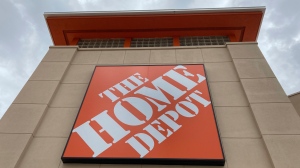A Home Depot logo sign hands on its facade, Friday, May 14, 2021, in North Miami, Fla. Home Depot's sales rose in its fiscal second quarter, buoyed by continued demand for items related to home improvement projects. (AP Photo/Wilfredo Lee, File) 