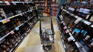 A person's purchases are seen in a shopping cart at a government-run BC Liquor Store in Vancouver, on Friday, August 19, 2022.. THE CANADIAN PRESS/Darryl Dyck