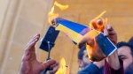 Protesters burn Swedish and Netherlands flags outside Mohammad al-Amin Mosque to denounce the recent desecration of Islam's holy book by far-right activists, in Beirut, Lebanon, on Jan. 27, 2023. (Hassan Ammar / AP) 
