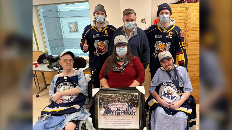 Barrie Colts players Brandt Clarke and Jacob Frasca and owner Howie Campbell visit Jeff and Sean and their support worker Melanie Smith of Empower Simcoe at Royal Victoria Regional Health Centre. Jan. 27, 2023 (Credit/Empower Simcoe)