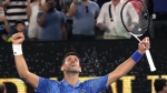 Novak Djokovic of Serbia celebrates after defeating Tommy Paul of the U.S. in their semifinal at the Australian Open tennis championship in Melbourne, Australia, Friday, Jan. 27, 2023. (AP Photo/Aaron Favila)
