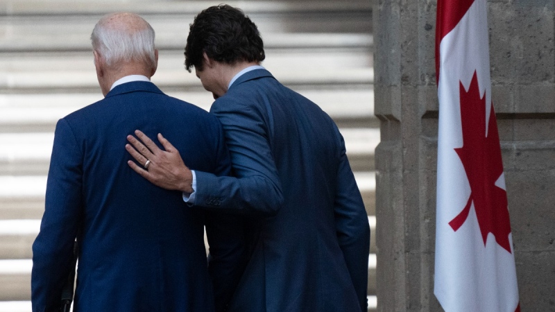 Prime Minister Justin Trudeau puts his hand on United States President Joe Biden at the North American Leaders Summit in Mexico City, Mexico, on Jan. 10, 2023. (Adrian Wyld / THE CANADIAN PRESS)