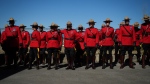 RCMP officers in Red Serge wait for a change of command ceremony and parade to begin for incoming B.C. RCMP Commanding Officer, Deputy Commissioner Dwayne McDonald, in Langley, B.C., on Tuesday, September 20, 2022. (THE CANADIAN PRESS/Darryl Dyck)