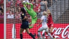 Canada keeper Erin McLeod makes a save in front of England's Katie Chapman (16) during second half FIFA Women's World Cup quarterfinal soccer action in Vancouver, B.C., on Saturday June 27, 2015. (THE CANADIAN PRESS/Darryl Dyck)