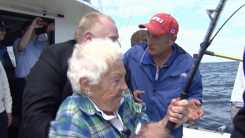 Ford holds McCallion as she reels in a fish