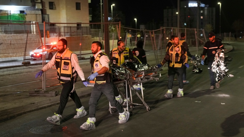 Members of Zaka Rescue and Recovery team recover a body after a shooting attack near a synagogue in Jerusalem on Jan. 27, 2023.  (AP Photo/Mahmoud Illean)