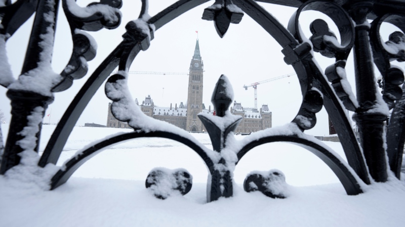 Snow covers a fence surrounding Parliament Hill, Friday, Jan. 20, 2023 in Ottawa. THE CANADIAN PRESS/Adrian Wyld 