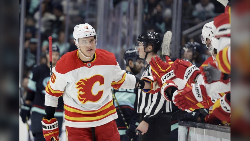 Calgary Flames defenseman Nikita Zadorov (16) is congratulated after scoring against the Seattle Kraken during the first period of an NHL hockey game, Friday, Jan. 27, 2023, in Seattle. (AP Photo/John Froschauer)
John Froschauer