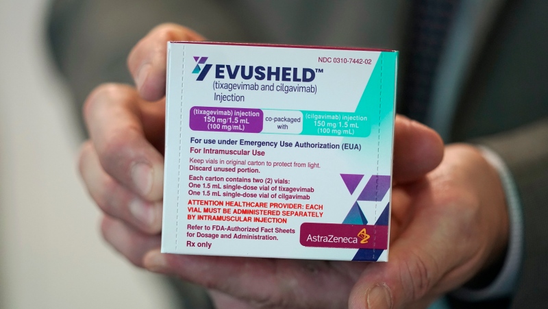 Scott Madow, a heath services manager at a University of Washington Medicine clinic, poses for a photo as he holds a box of AstraZeneca's Evusheld, the first set of antibodies grown in a lab to prevent COVID-19, Thursday, Jan. 20, 2022, in Seattle. (AP Photo/Ted S. Warren)