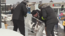 A block of ice is brought out for carving at Winterloo. (Tyler Kelaher/CTV News)