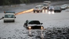 Vehicles are stranded by flood water in Auckland, Saturday, Jan 28, 2023. (Dean Purcell/New Zealand Herald via AP)