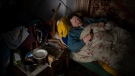 Suffering from cancer, Gennadiy Shaposhnikov, 83, rests in his partially destroyed home which was hit by Russian shelling last fall in Kalynivske, Ukraine on Jan. 28, 2023. (AP Photo/Daniel Cole)