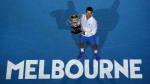 Novak Djokovic of Serbia holds the Norman Brookes Challenge Cup after defeating Stefanos Tsitsipas of Greece in the men's singles final at the Australian Open tennis championship in Melbourne, Australia, on Jan. 29, 2023. (AP Photo/Ng Han Guan)