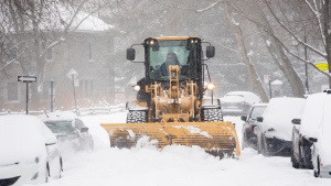 A plow clears a street during a snowstorm in Montreal, Friday, February 18, 2022, following a snowstorm in the city. THE CANADIAN PRESS/Graham Hughes