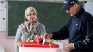 A Tunisian votes in the second round of the legislative elections in Tunis, Jan. 29, 2023. (AP Photo/Hassene Dridi)