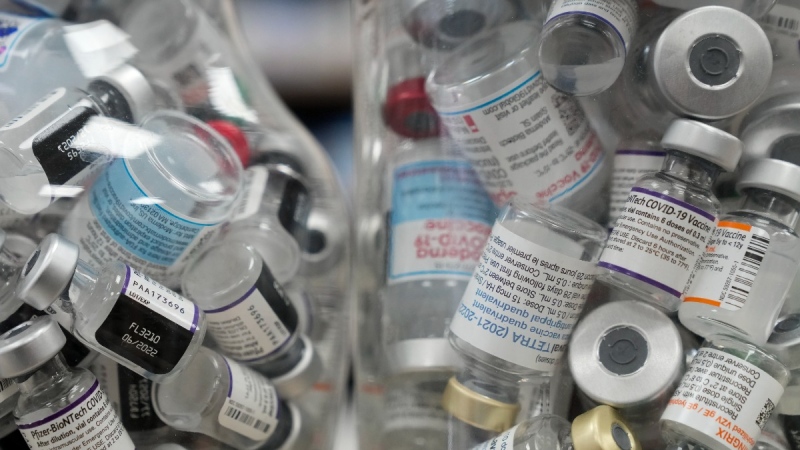 Jars full of empty COVID-19 vaccine vials are shown at the Junction Chemist pharmacy during the COVID-19 pandemic in Toronto on April 6, 2022. (Nathan Denette / THE CANADIAN PRESS)