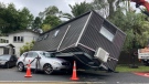 A portable building rests on a car after flood water shifted the structure in Auckland, on Jan. 28, 2023. (Elizabeth Binning / New Zealand Herald via AP)