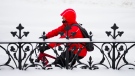A cyclist rides along past Parliament Hill in Ottawa on Monday, Jan. 30, 2023. (Sean Kilpatrick/THE CANADIAN PRESS)