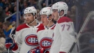 Montreal Canadiens' Christian Dvorak, center, is congratulated by teammates Josh Anderson, left, and Kirby Dach (77) after scoring during the third period of an NHL hockey game Saturday, Oct. 29, 2022, in St. Louis. (AP Photo/Jeff Roberson)