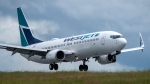 A WestJet flight arrives at the Halifax Stanfield International Airport in Goffs, N.S. on Monday, July 6, 2020. (THE CANADIAN PRESS/Andrew Vaughan)