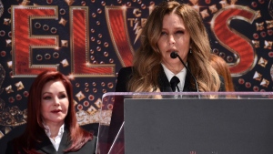 Priscilla Presley, former wife of the late singer Elvis Presley, left, looks on as her daughter Lisa Marie Presley, speaks at the TCL Chinese Theatre in Los Angeles, on June 21, 2022. (Jordan Strauss / Invision / AP) 